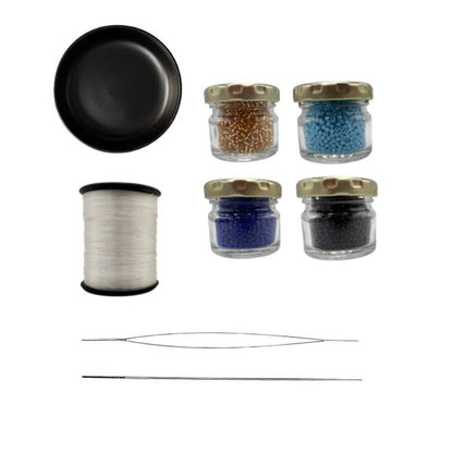Collection of fly tying materials including a black bowl, spool of thread, and small jars with beads on a white background.